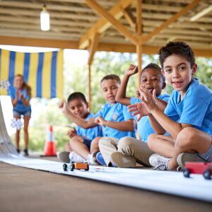 Cub Scouts racing cars on a Pinewood Derby track